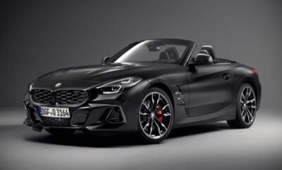A sleek black convertible sports car with red brake calipers.