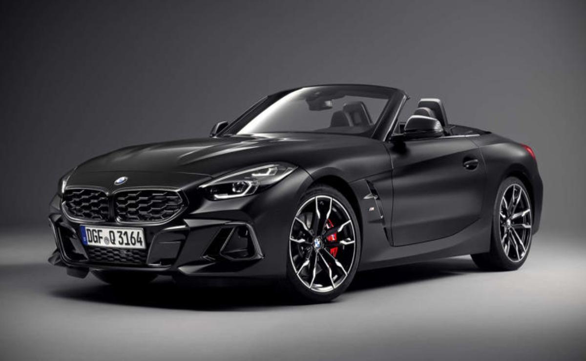 A sleek black convertible sports car with red brake calipers.