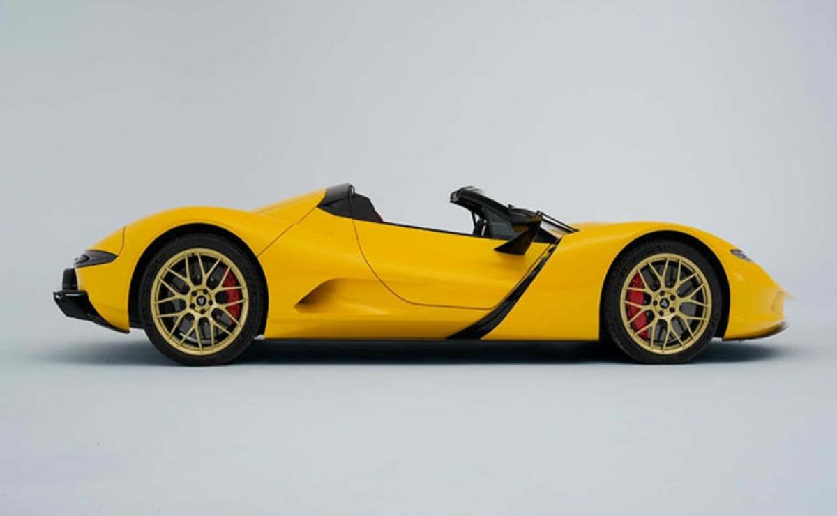 A sleek yellow convertible sports car with black accents and red-rimmed wheels.