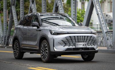Silver SUV parked on a bridge with modern design elements.