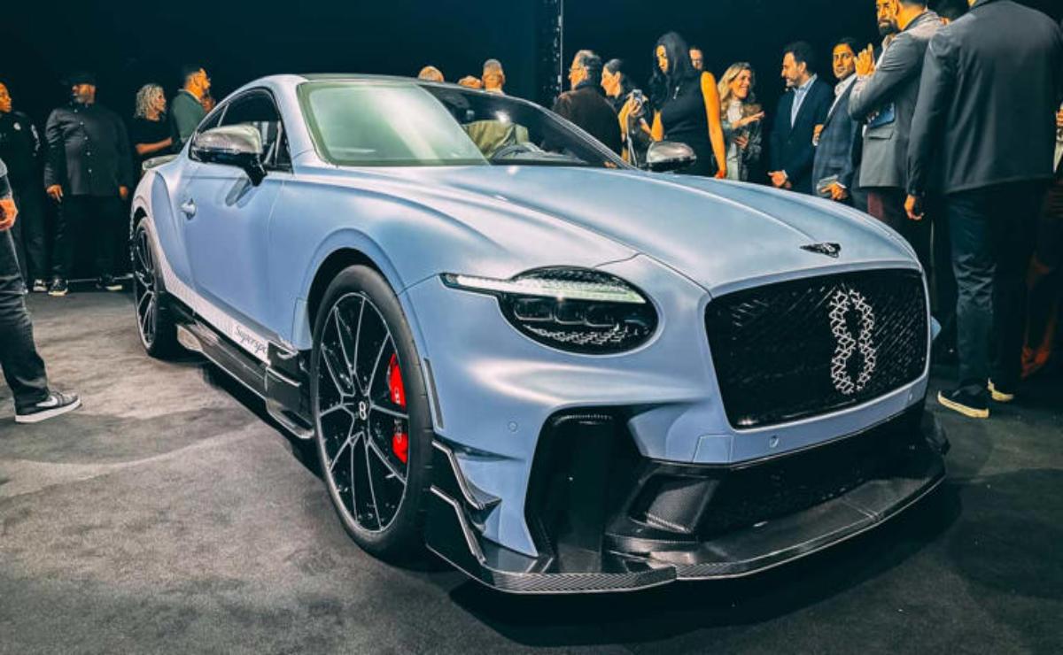 Sleek silver sports car with black rims on display.