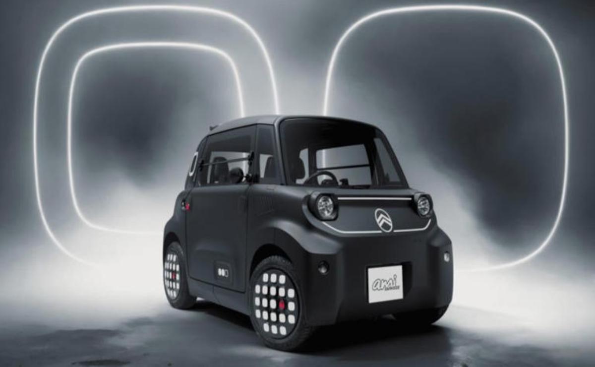 Compact black electric car with futuristic design and unique wheel lights.