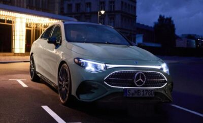 A sleek white Mercedes-Benz parked on a city street at dusk.
