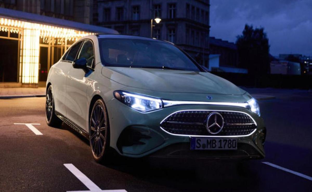 A sleek white Mercedes-Benz parked on a city street at dusk.