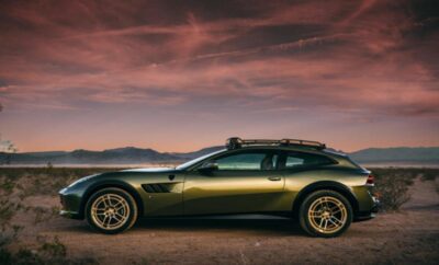 A sleek sports car parked on a desert road at sunset.
