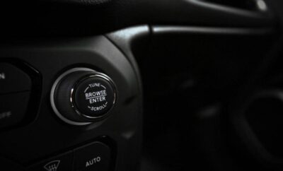 Close-up of a car's engine start/stop button.