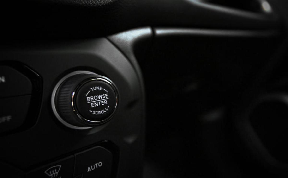 Close-up of a car's engine start/stop button.