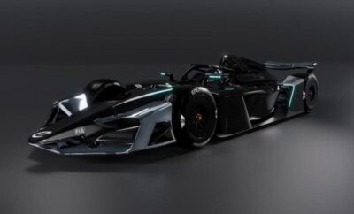 Futuristic black race car with sleek aerodynamic design under studio lights.