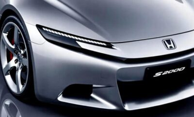Close-up of a sleek silver car front with futuristic LED headlights.