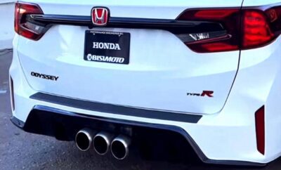 Rear view of a white Honda Civic Type R with triple exhaust pipes.