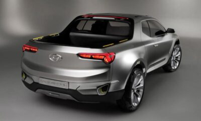Silver pickup truck with sleek, modern design and large wheels.