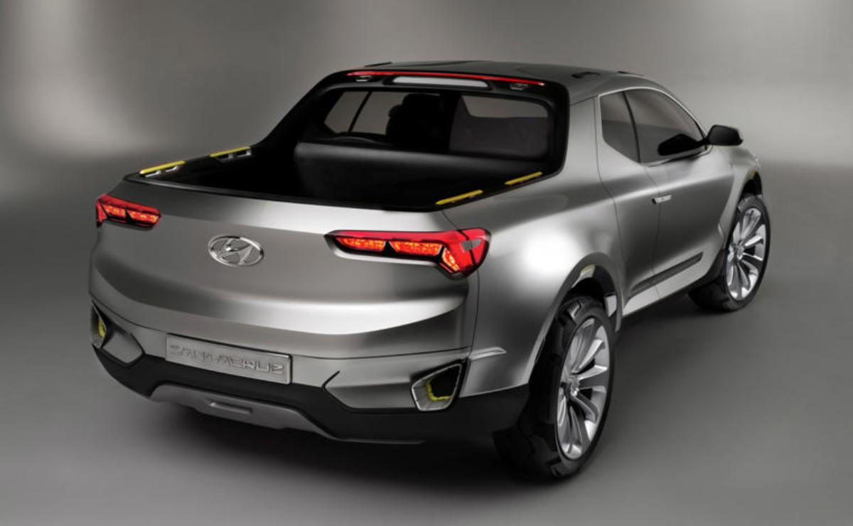 Silver pickup truck with sleek, modern design and large wheels.