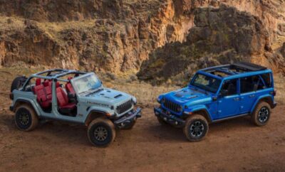 Two rugged off-road vehicles parked on a dirt trail in a rocky canyon.