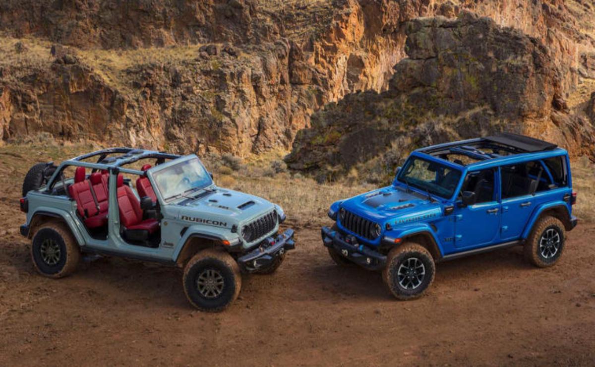 Two rugged off-road vehicles parked on a dirt trail in a rocky canyon.