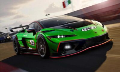 A sleek green sports car with racing decals on a track.