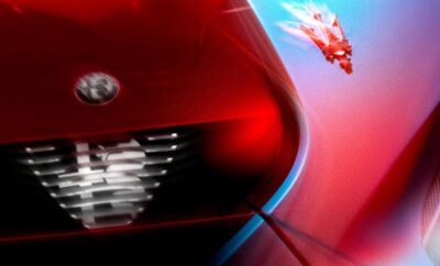 Close-up of a red sports car's headlight and grille.