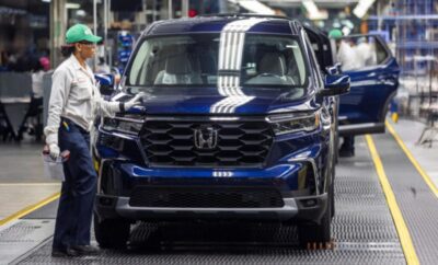 A blue Honda SUV on a factory assembly line.