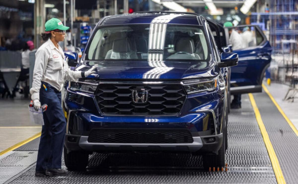 A blue Honda SUV on a factory assembly line.