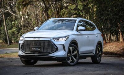 Sleek silver SUV parked on a forest road with modern design features.