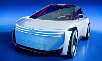 Futuristic Peugeot concept car with sleek design and illuminated logo.