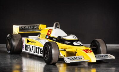 Yellow and white Renault Formula 1 race car on display.