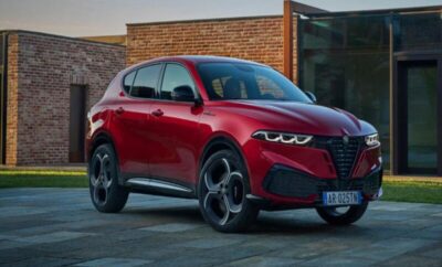 Red Alfa Romeo SUV parked outside a modern building.