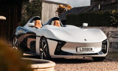 Sleek white two-seater sports car parked outdoors.