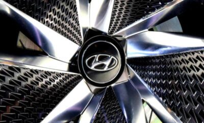 Close-up of a shiny Hyundai car wheel rim with logo.
