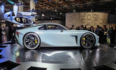 Sleek silver sports car displayed at an auto show.