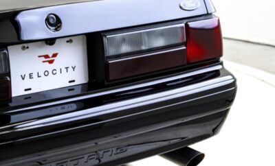 Close-up of a classic car's rear light and bumper detail.