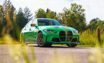 A vibrant green BMW car parked on a sunny road.
