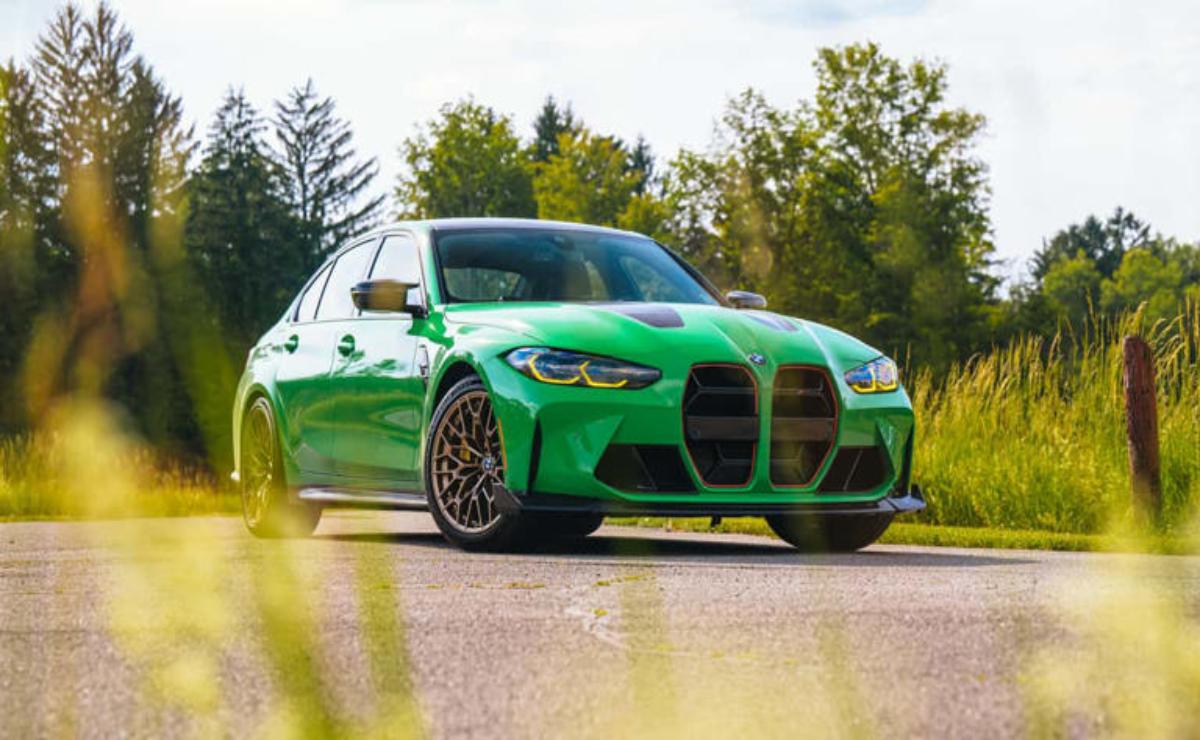 A vibrant green BMW car parked on a sunny road.
