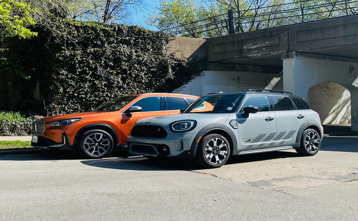 Two modern Mini Cooper cars parked side by side outdoors.
