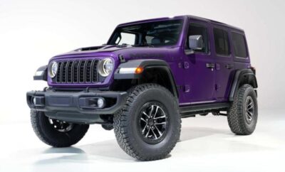 A purple Jeep Wrangler with off-road tires on a white background.
