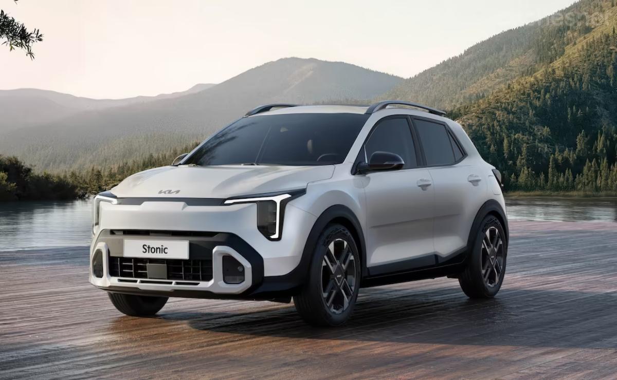 Sleek white electric SUV driving on a road with mountains in the background.
