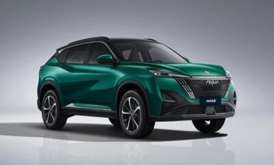 A sleek green Mahindra XUV700 SUV parked with a modern design.