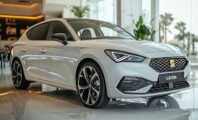 A sleek white modern sedan showcased indoors with stylish alloy wheels.
