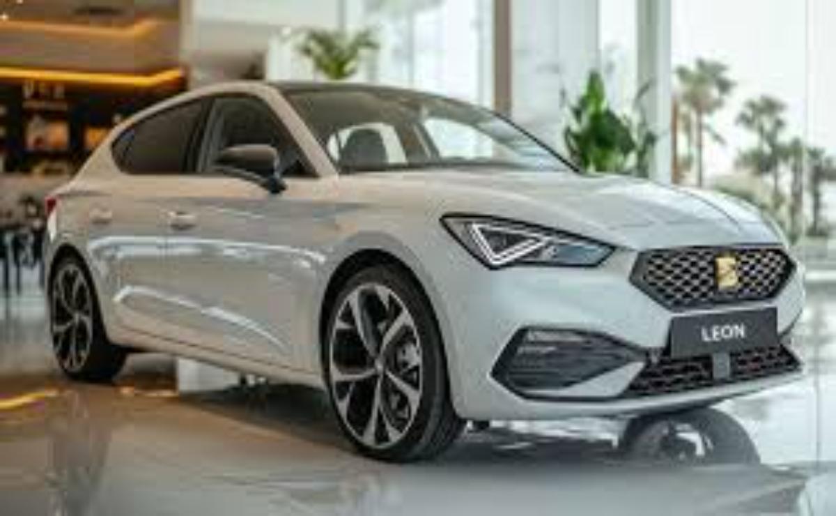 A sleek white modern sedan showcased indoors with stylish alloy wheels.
