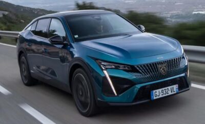 A sleek blue electric SUV driving on a road.