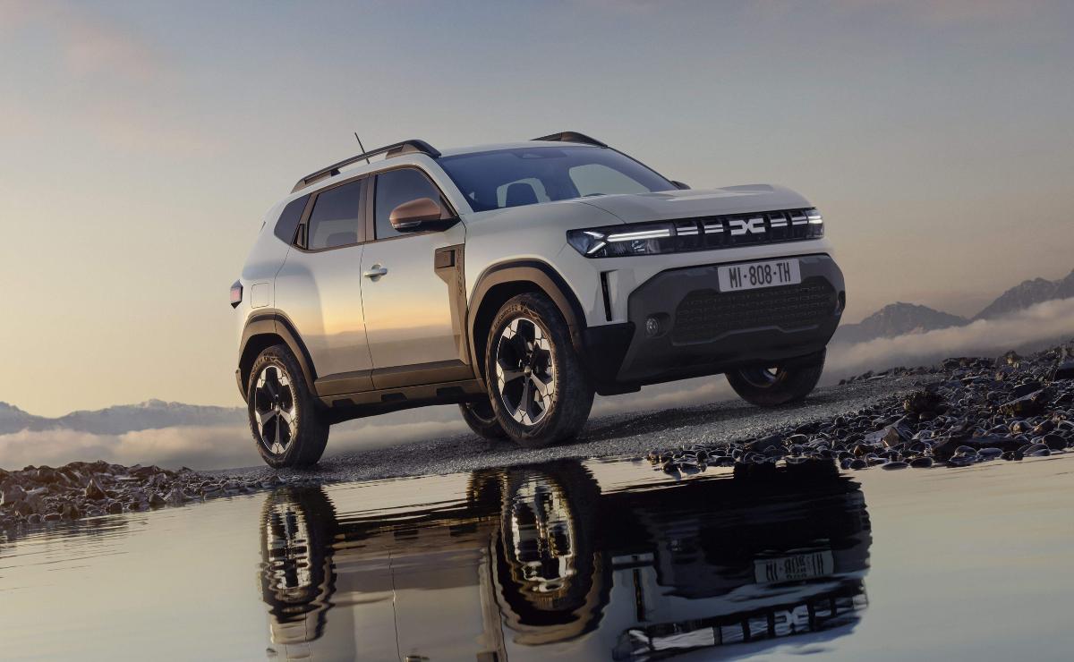 A modern silver SUV parked near water, reflecting its sleek design.
