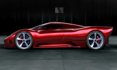 Sleek red sports car with polished silver rims in a dark setting.