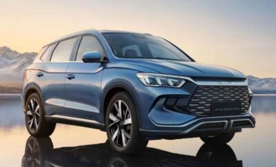 Sleek blue SUV with modern design at sunset.