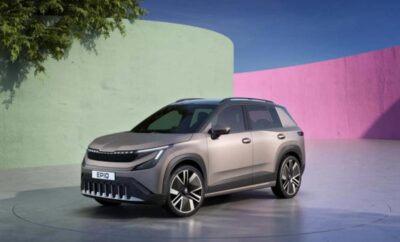 Modern electric SUV parked with colorful walls in the background.
