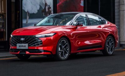 Sleek red modern sedan with stylish design and sharp headlights.