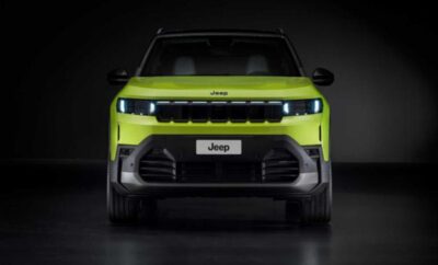 Front view of a bright green Jeep with sleek headlights and bold grille design.