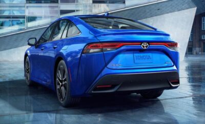 Sleek blue Toyota electric car showcased indoors.