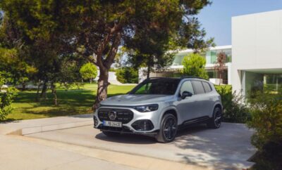 Silver Mercedes-Benz SUV parked under a tree in a sunny area.