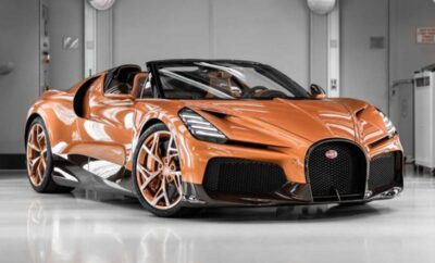 A sleek orange Bugatti sports car in a showroom.