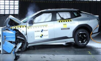 Car undergoing a crash test with visible damage and airbags deployed.