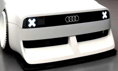 Close-up of a white Audi car grille with the logo and design details.